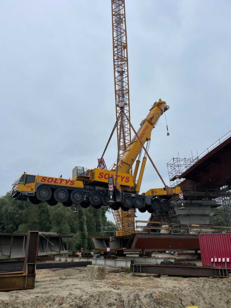 Realizacja podnoszenia przez doświadczonych operatorów z firmy Dźwigi Sołtys. Dźwig podnosi dźwig.